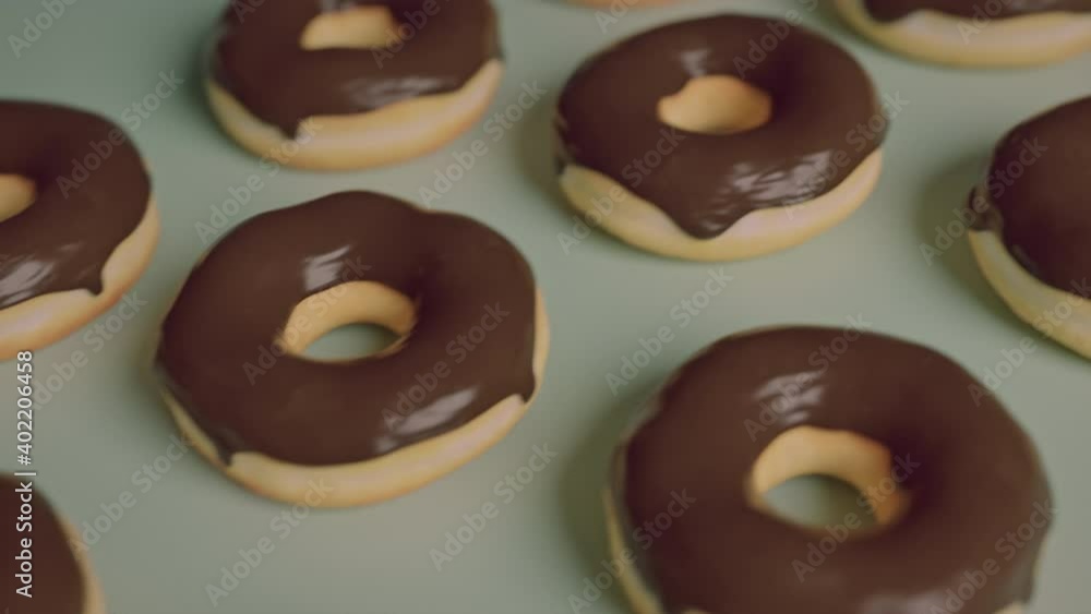 Chocolate frosting donuts on a green background Chocolate frosting donuts on a green background