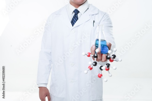 Fototapeta Naklejka Na Ścianę i Meble -  A chemist holding a flask