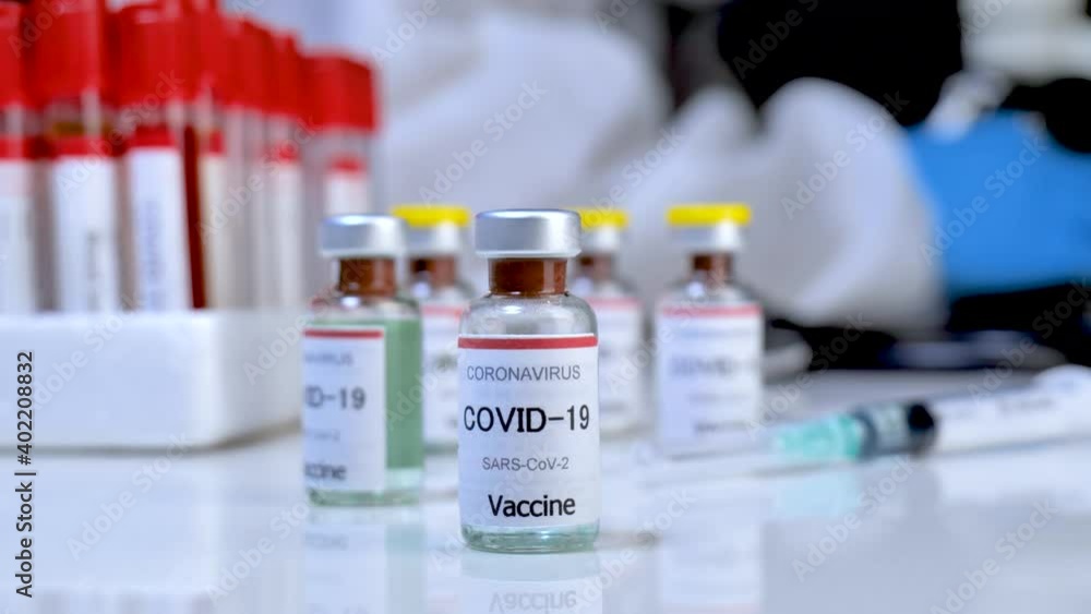Concept fight against virus covid-19 coronavirus, doctor or scientist in laboratory holding a syringe with liquid vaccines for children or older adults, Concept: diseases, medical care, slow-motion. Concept fight against virus covid-19 coronavirus, doctor or scientist in laboratory holding a syringe with liquid vaccines for children or older adults, Concept: diseases, medical care, slow-motion.