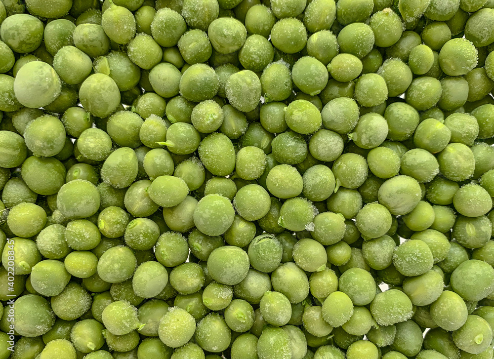 Frozen green peas texture. Healthy vegetables in the freezer. Top view closeup. Frozen green peas texture. Healthy vegetables in the freezer. Top view closeup.