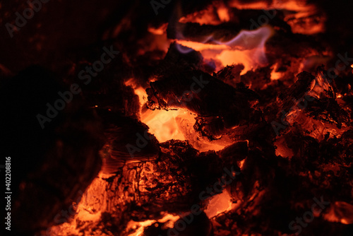 embers, fire, flames and burnt wood of bonfire, concept of burn and relaxation