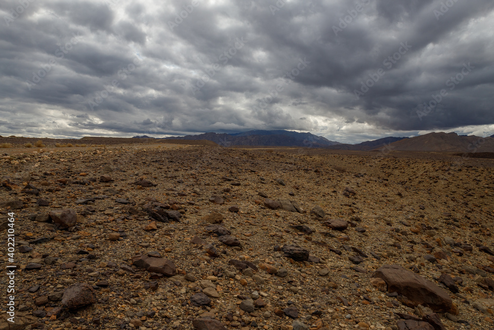the Ethiopian desert where the earth is brown and the sky is dramatically dark moaning in contrast