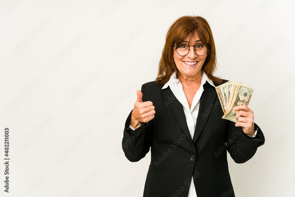 Middle age caucasian business woman holding banknotes isolated smiling and raising thumb up Middle age caucasian business woman holding banknotes isolated smiling and raising thumb up