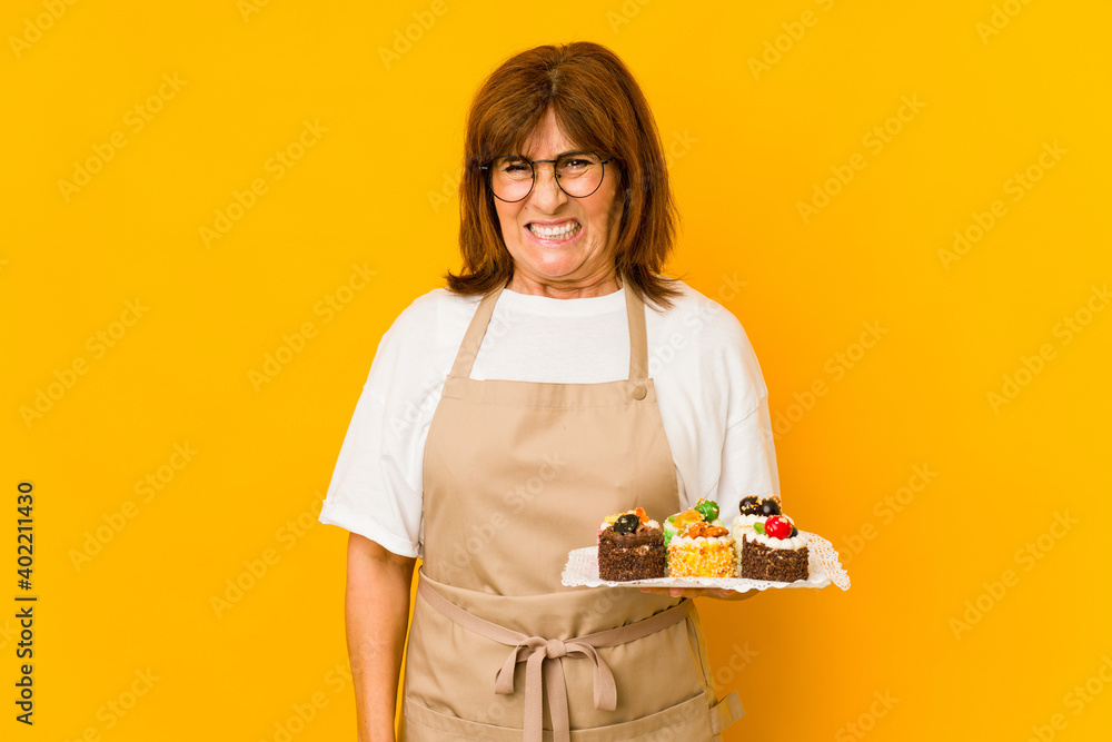 Middle age caucasian cook woman screaming very angry and aggressive. Middle age caucasian cook woman screaming very angry and aggressive.
