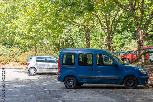 Fototapeta Naklejka Na Ścianę i Meble -  Cars in a parking in a public park
