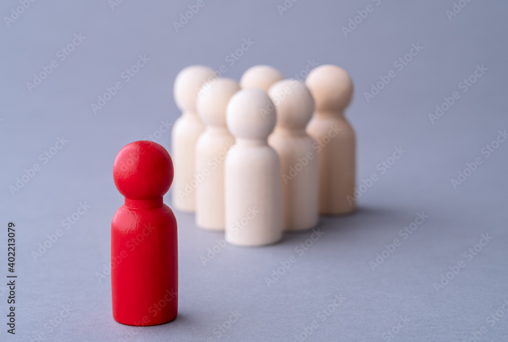 Leadership concept, red figure of a man made of wood, standing out from the crowd of. Different people. Run to new opportunities. Talent management, Recruitment employee, Good business team leader. Leadership concept, red figure of a man made of wood, standing out from the crowd of. Different people. Run to new opportunities. Talent management, Recruitment employee, Good business team leader.