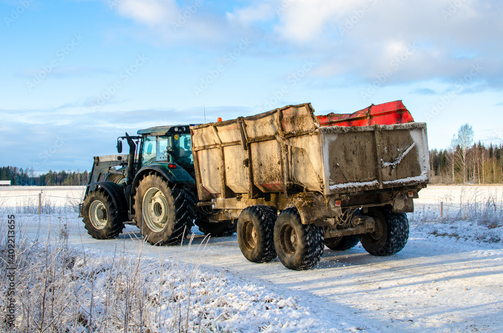 Fototapeta premium A tractor truck on a snowy countryside road, Turi, Estonia
