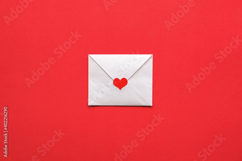 Valentine's card on a red background. White envelope with red heart