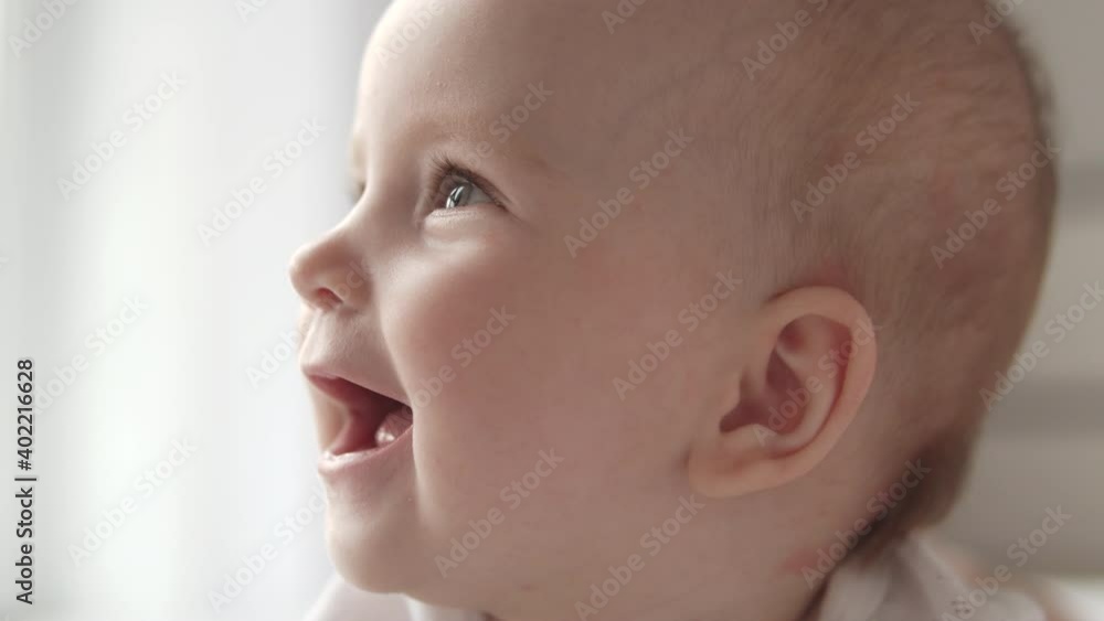 Excited newborn smiling, baby growth and development, happy childhood moments Excited newborn smiling, baby growth and development, happy childhood moments