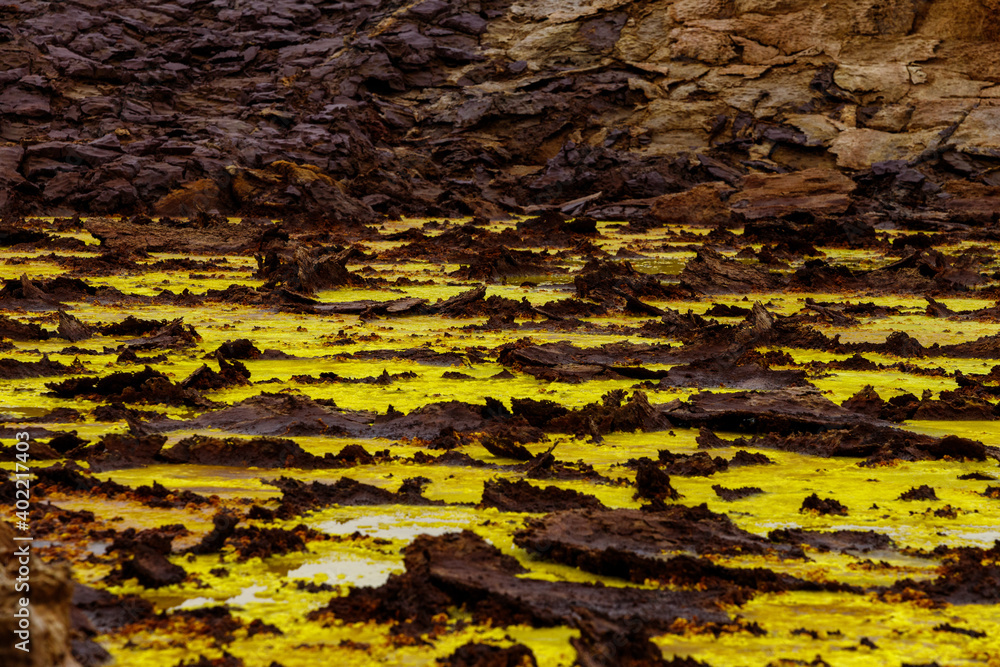 yellow and red stones in a volcanic crater that smokes and boils from the heat, they look like egg yolk with chocolate yellow and red stones in a volcanic crater that smokes and boils from the heat, they look like egg yolk with chocolate