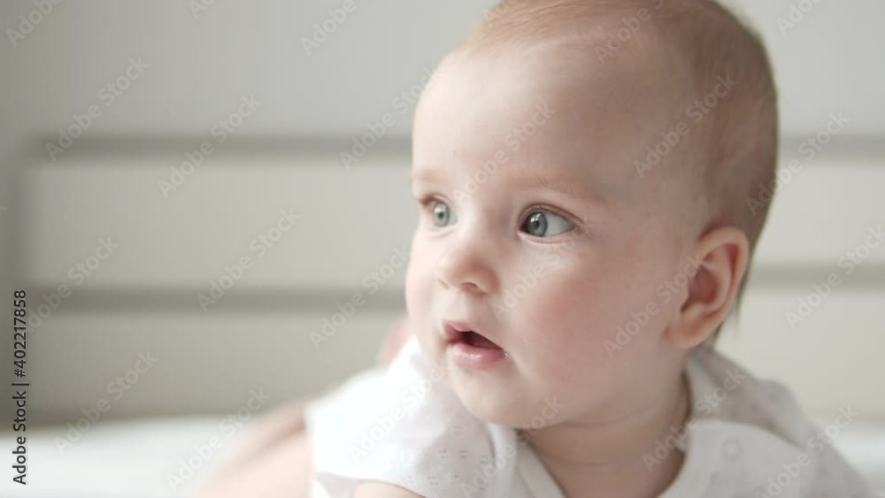 Female toddler lying on bed, newborn care and safety, baby basic needs, growth Female toddler lying on bed, newborn care and safety, baby basic needs, growth