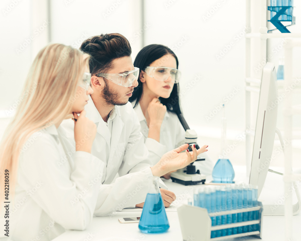 team of scientists discussing something at the Desk team of scientists discussing something at the Desk