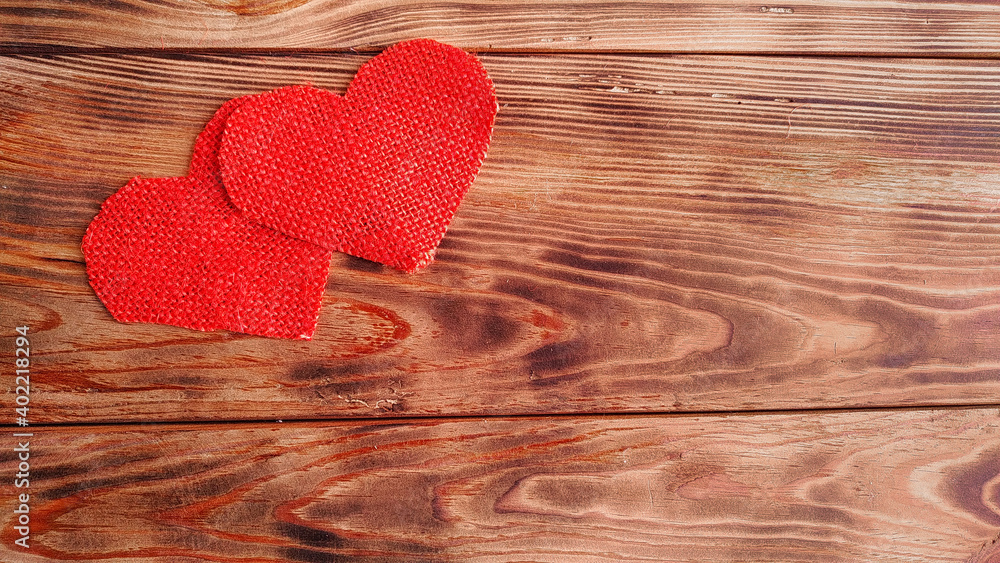 background for valentine's day card. hearts of red canvas on a wooden background background for valentine's day card. hearts of red canvas on a wooden background