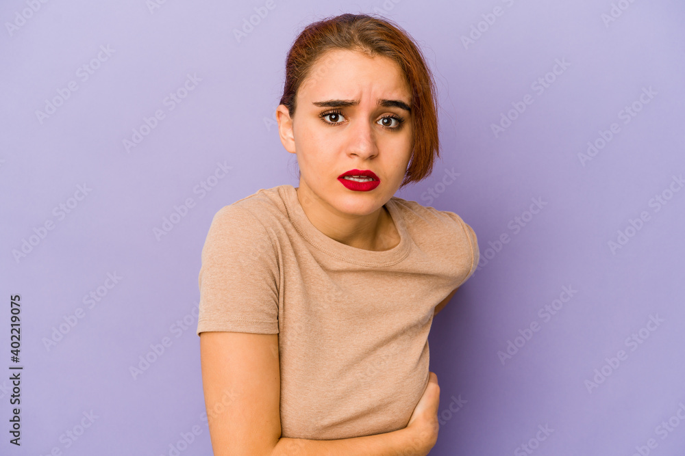 Fototapeta premium Young arab mixed race woman having a liver pain, stomach ache.