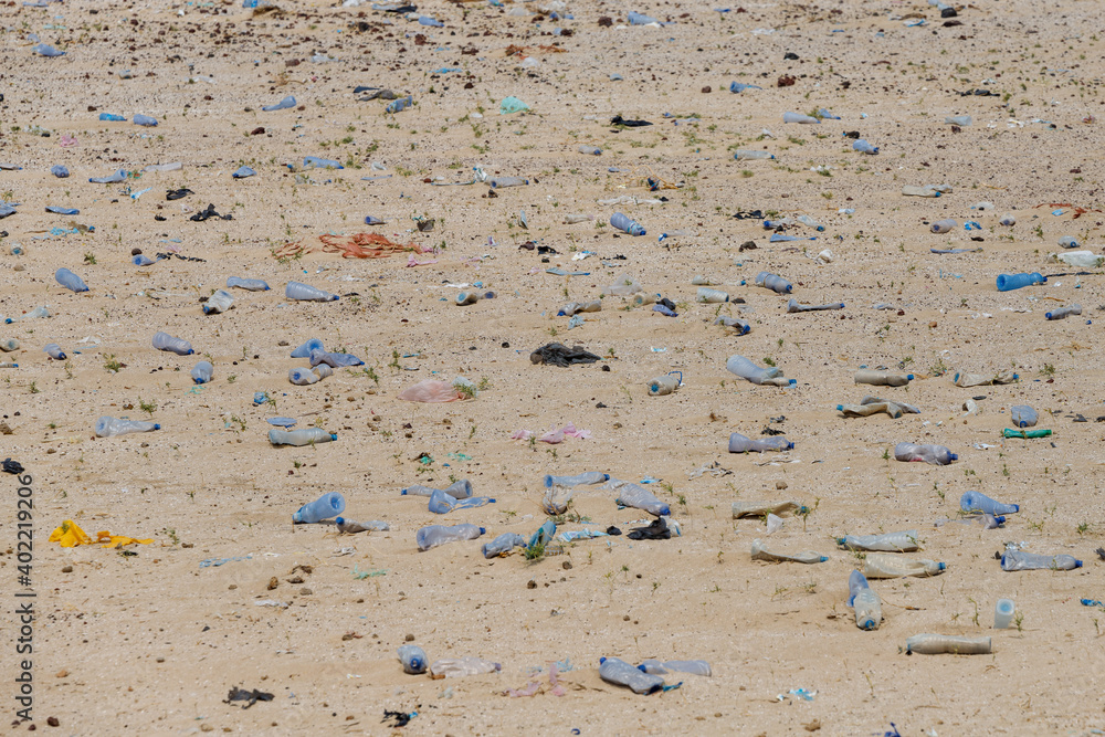 in the desert tossed in the sand a lot of plastic bottles and other waste in the desert tossed in the sand a lot of plastic bottles and other waste
