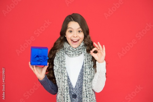 Fotografie stylish child girl in casual warm apparel with box after successful seasonal sho