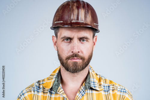 man architect with serious look. guy wear worker uniform. handsome builder in helmet. mature man wear checkered shirt. professional constructor or mechanic. builder engineer © be free
