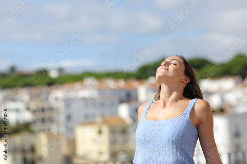 Woman relaxing breathing fresh air in a town