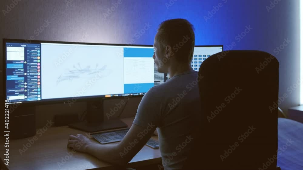 The engineer working on wide screen computer, realtime The engineer working on wide screen computer, realtime