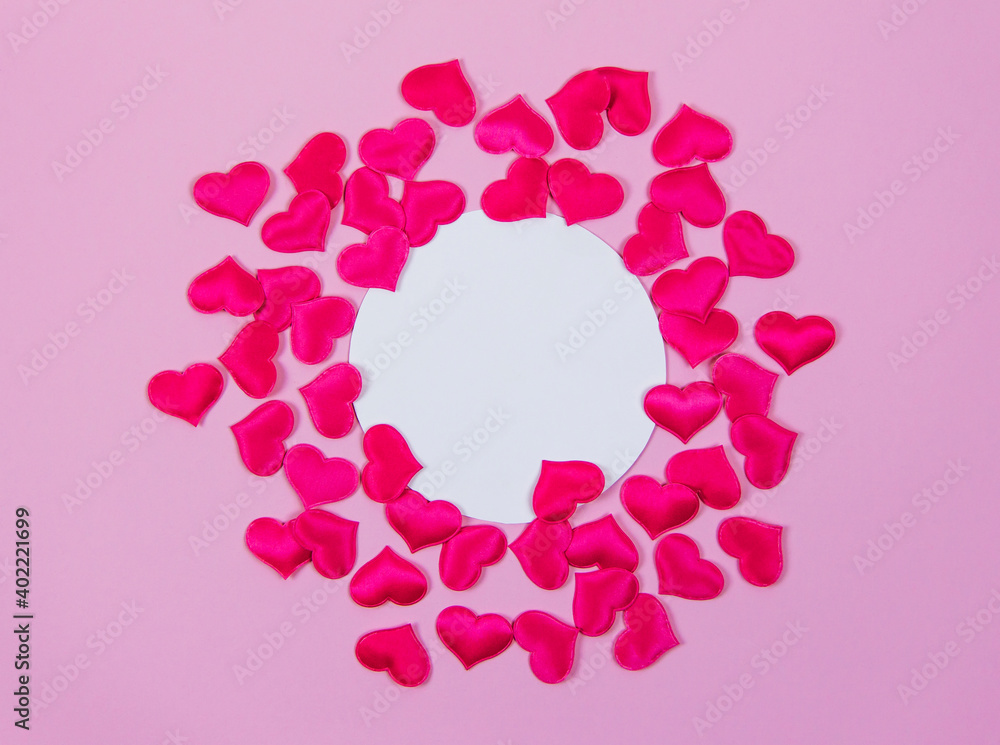 Pink hearts on pink background around round card for text, Valentine's day love concept