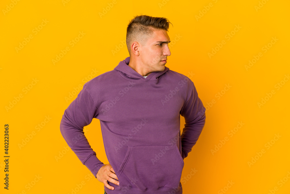 Young handsome caucasian man isolated suffering a back pain. Young handsome caucasian man isolated suffering a back pain.