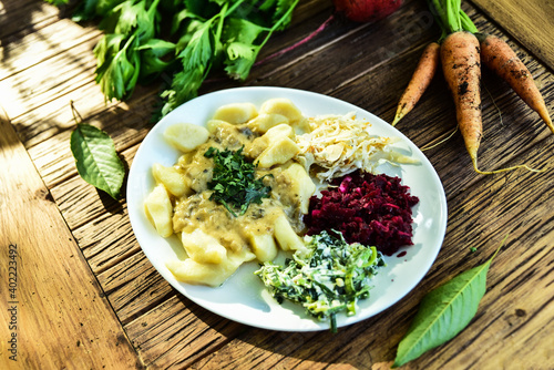 Traditional potato dumplings with several types of salads.