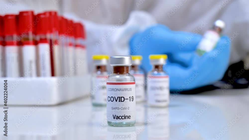 Concept fight against virus covid-19 coronavirus, doctor or scientist in laboratory holding a syringe with liquid vaccines for children or older adults, Concept: diseases, medical care, slow-motion. Concept fight against virus covid-19 coronavirus, doctor or scientist in laboratory holding a syringe with liquid vaccines for children or older adults, Concept: diseases, medical care, slow-motion.