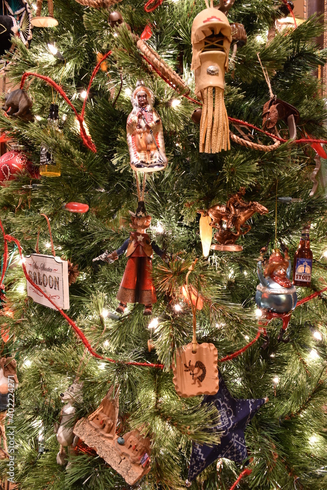 Western themed christmas tree decorated with cowboys, native americans, guns, hats, headdress