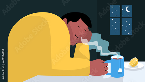 Man relaxing and dreaming while drinking tea during winter time at home with window and moon in the background. Tea time and relax concept.