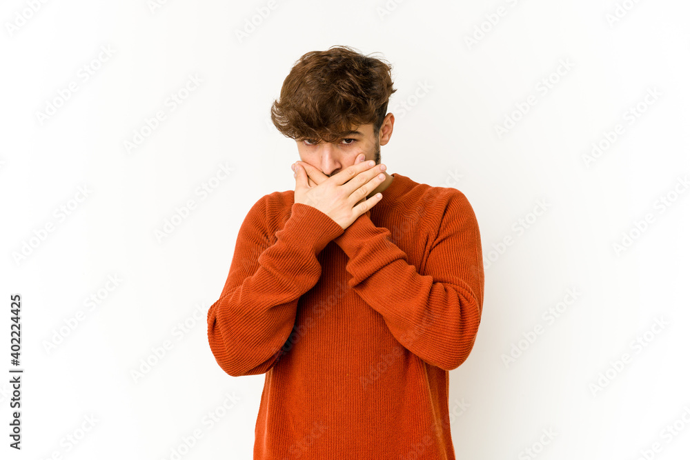Young arab man on white background covering mouth with hands looking worried. Young arab man on white background covering mouth with hands looking worried.