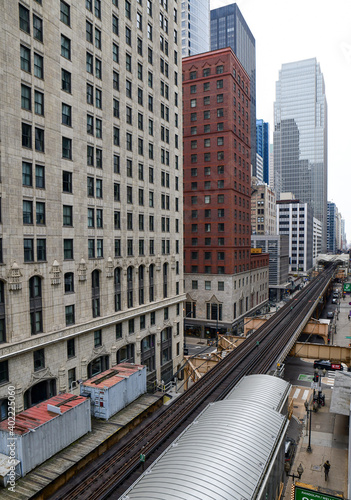 High angle view of vintage commuter train and tracks in among the city skyscrapers