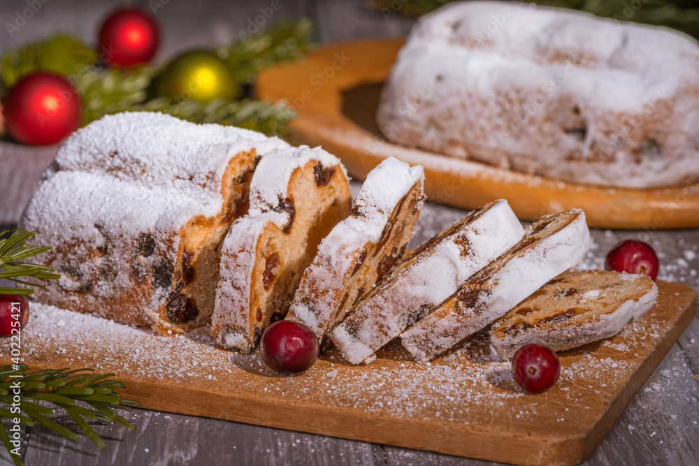 Christmas marzipan stollen cake with icing sugar, marzipan and raisins.