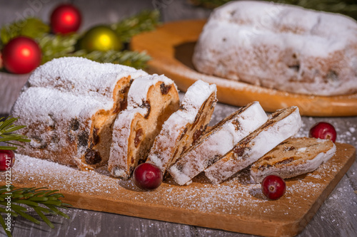 Obraz na płótnie Christmas marzipan stollen cake with icing sugar, marzipan and raisins. w salonie