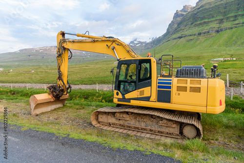 Empty excavator in a construction site along a mountain road in Iceland