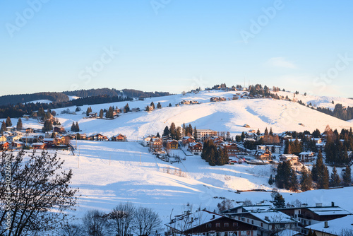 Snow covered mountain town at sunset