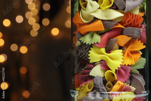 Different colored pasta in a glass, closeup photo