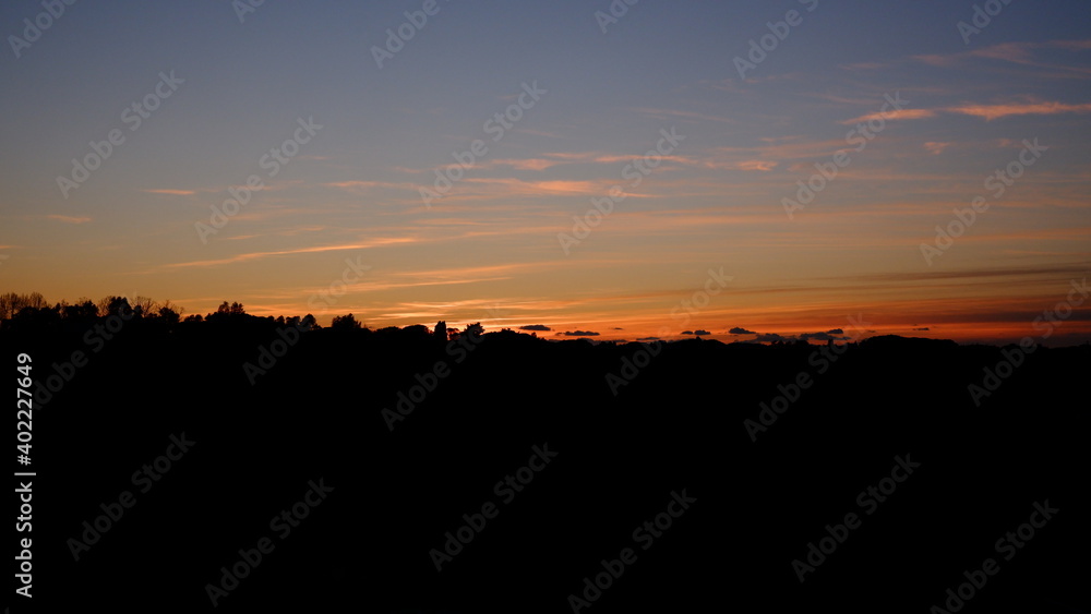 Red summer sunset sky panorama. Dark vibrant colors.