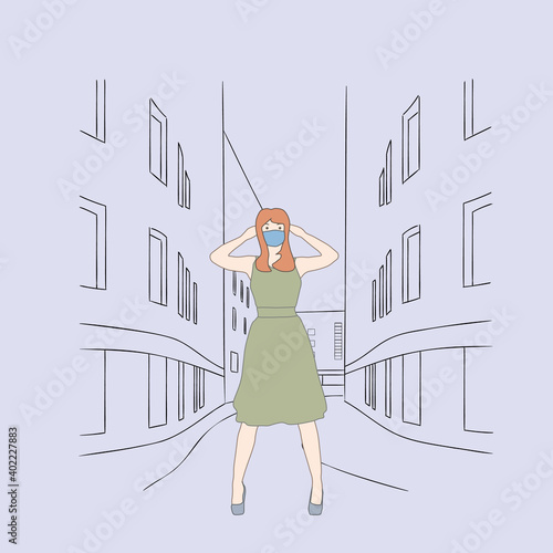 Girl in dress stands on the street wearing a mask.