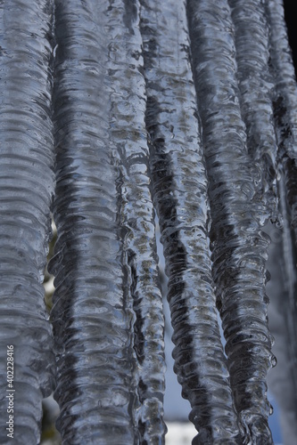 Closeup shot of natural rippled icicle formation due to water impurity during winter.
