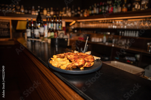 Amazing portrait of a delicious dish of chicken and potatoes placed on a bar counter