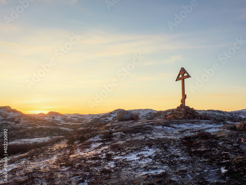Cross on the Kola Peninsula, cold dawn in Teriberka