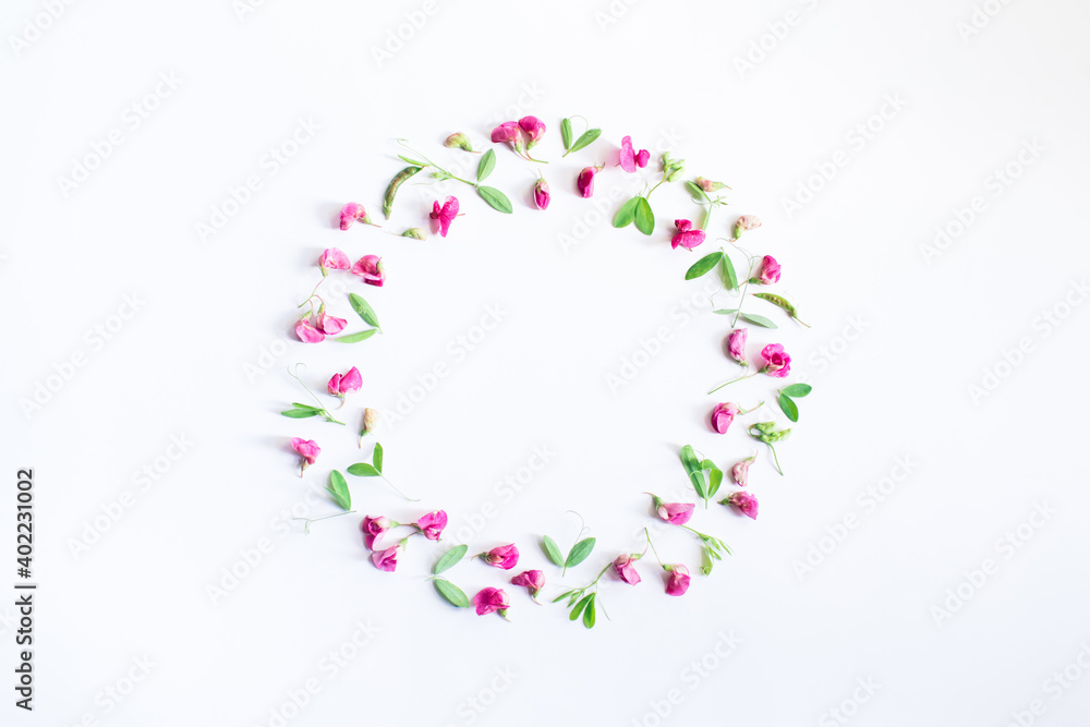 Flowers composition. Wreath made of pink flowers and leaves on white background. Spring, easter, summer concept. Flat lay, top view, copy space.