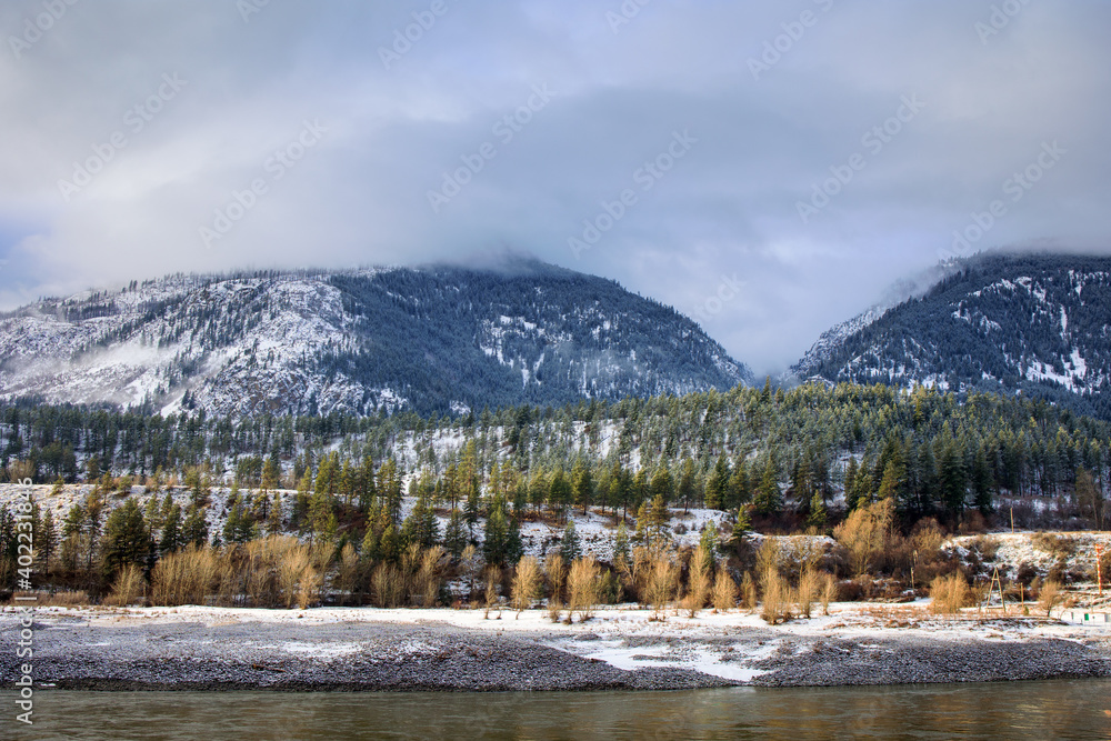 Scenic snow covered forests and mountains along Fraser River in Fraser Canyon