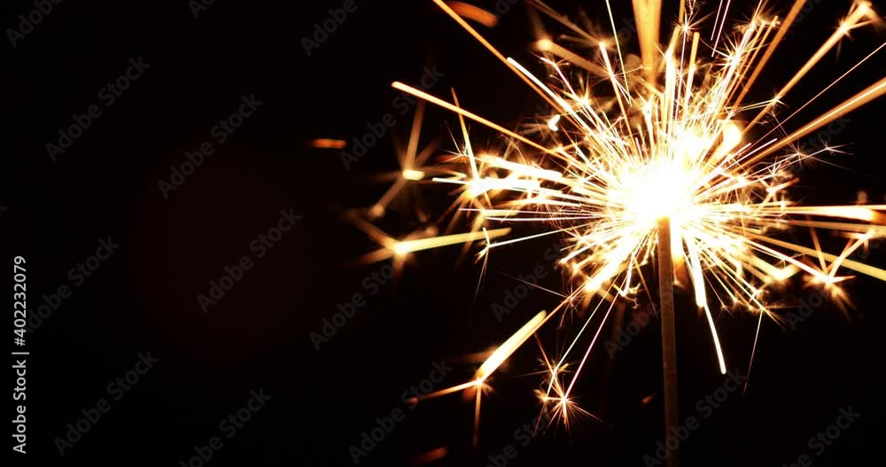 Sparkler burning on black background, close-up. Sparkler burning on black background, close-up.