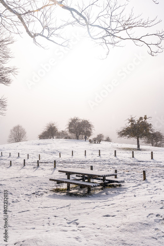 Snowy sunrise at the picnic area next to the refuge of Mount Aizkorri in Gipuzkoa. Snowy landscape by winter snows. Basque Country, Spain