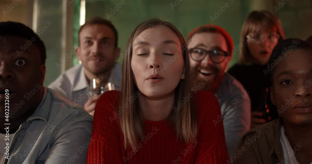 Excited diverse friends looking at tv screen with interest while watching sport game on TV. Cheerful group of friends spending time to while sitting at table with beer and supporting team Excited diverse friends looking at tv screen with interest while watching sport game on TV. Cheerful group of friends spending time to while sitting at table with beer and supporting team