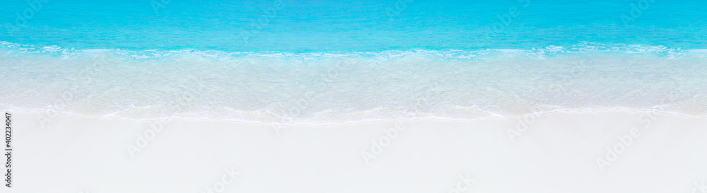 Tropical beach scene of azure crystal sea with soft waves. Long banner Tropical beach scene of azure crystal sea with soft waves. Long banner