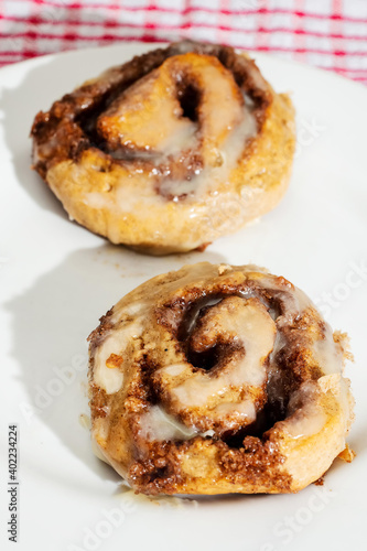 Hand made tasty cinnamon roll on a white plate. Pastry product.