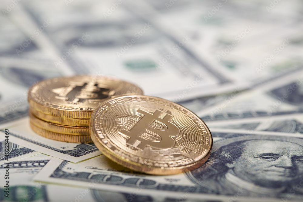 Bitcoins on dollar banknotes background Bitcoins on dollar banknotes background
