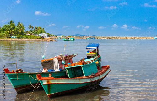 Vietnamese fishing boats on tropical island shore